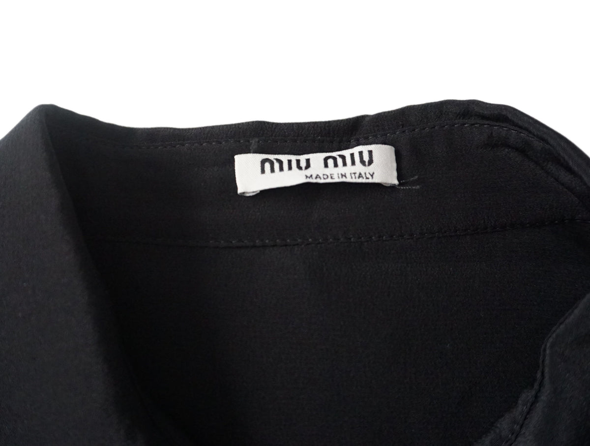 miu miu  - Blusa negra con cuello ondulad